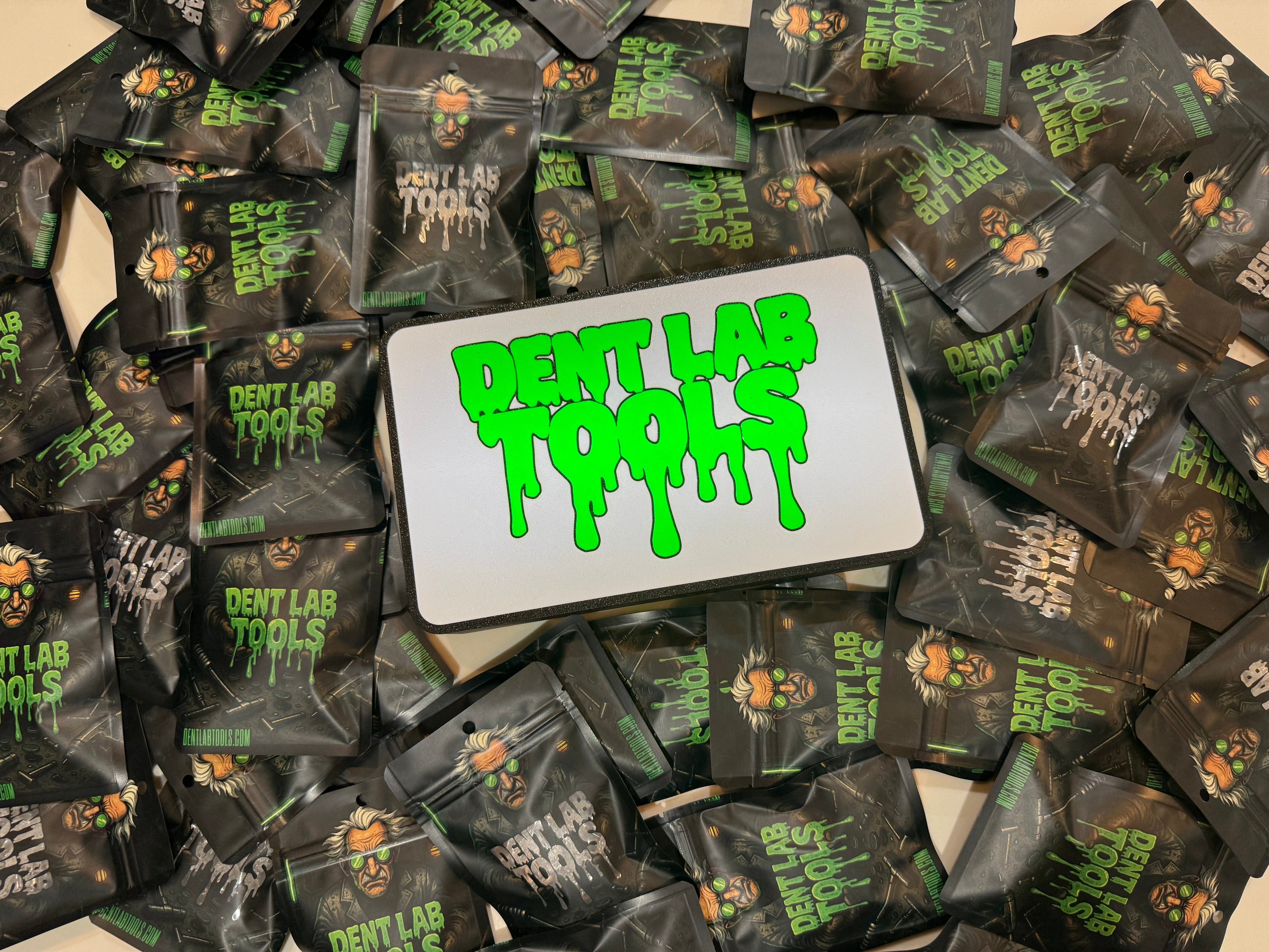 Dent Lab Tools packaging with green text on a white card, surrounded by similar black packages.